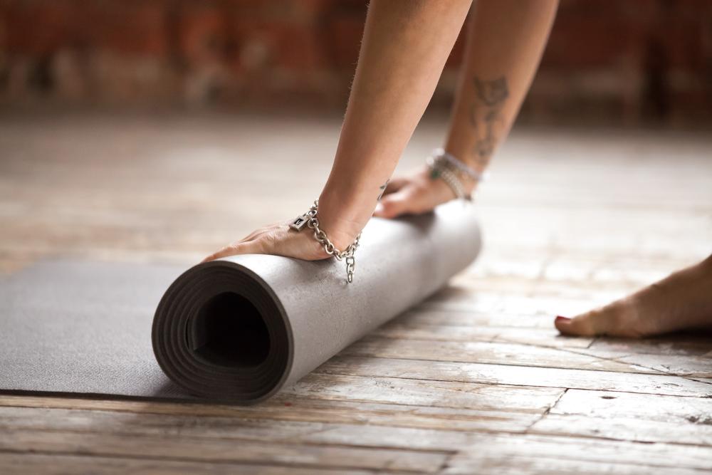 hands rolling fitness mat concept healthy lifestyle